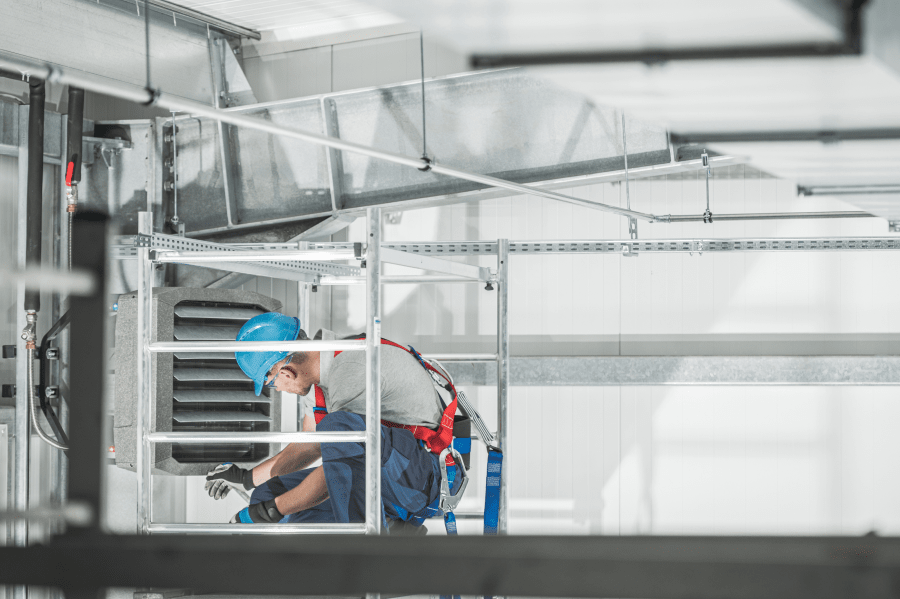 worker checking hvac installations of a building